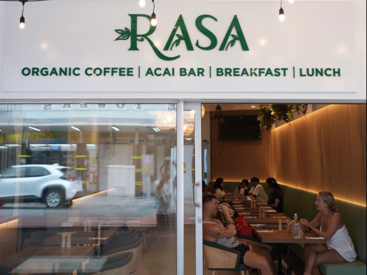 The Rasa shopfront by day: organic coffee, acai bar, breakfast and lunch on the sign, diners inside