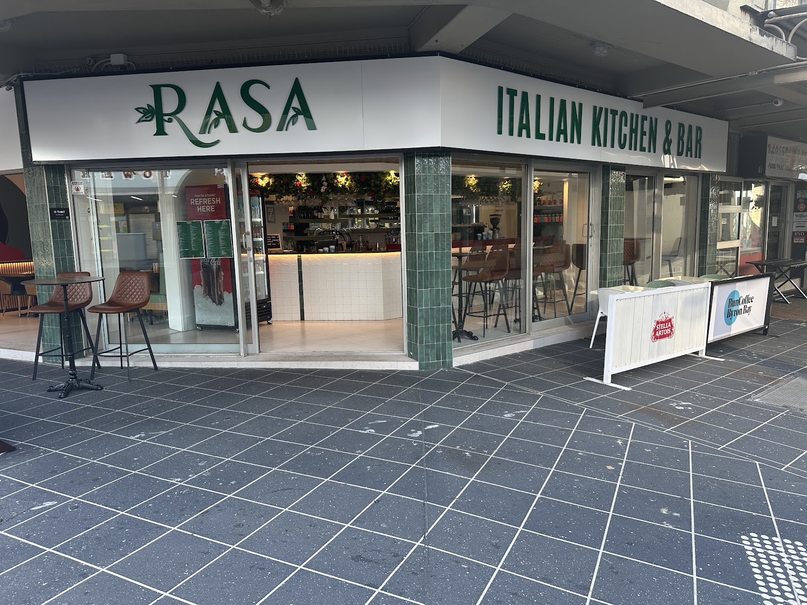 Rasa Italian Kitchen & Bar on Surfers Paradise Boulevard at dusk, the lit dining room seen through the front windows